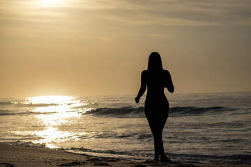Girl silhouette on beach at dawn 5