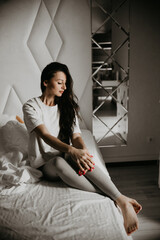 Woman sitting in bed, enjoying a peaceful moment