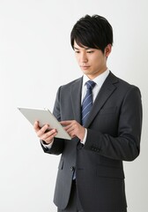 Photo of asian man business manager good and positive mood holding digital e-book tablet reading company report formal wear shirt blazer luxury suit white color background