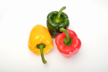 Yellow, red, and green pepper on a white background