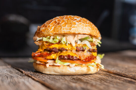 Juicy double cheeseburger with crispy bacon, fresh lettuce, and special sauce, served on a toasted bun.
