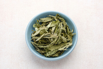 Stevia rebaudiana, dietary sweetener. Fresh and dried crushed stevia leaves. 
