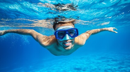 A skilled swimmer glides effortlessly through crystal-clear blue waters, showcasing a vibrant underwater world. The sunlight pierces through the surface, illuminating the serene abyss