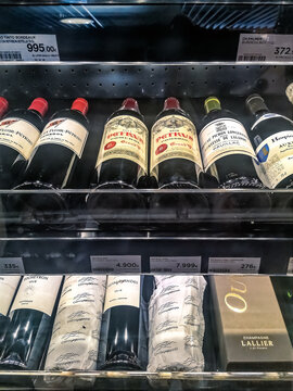 A selection of premium wines, including Chateau Petrus 2011 and 2018, displayed in a Madrid supermarket. Priced between 4,900 and 7,999 euros. Madrid, Spain - November 30, 2021