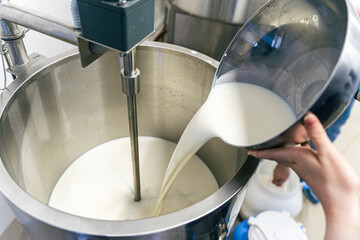 Stirring sour cream. Production of dairy products, butter and sour cream. Stirring sour cream....