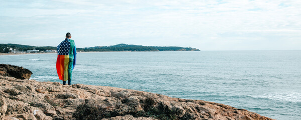 man wrapped in a rainbow US flag, banner format