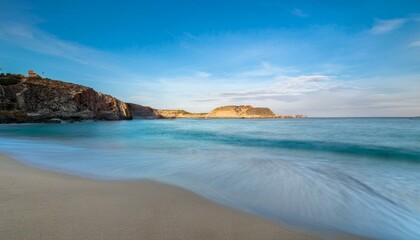 Obraz premium playa pariadisaca de arena fina blanca, con aguas cristalinas y cielo azul, en un precioso atardecer de hora dorada, concepto de postal de viaje