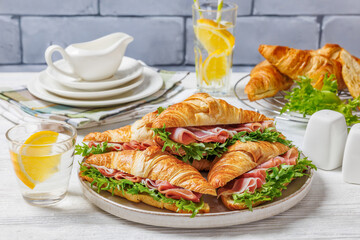 croissant sandwiches with ham and lettuce on plate
