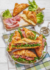 croissant sandwiches with ham and lettuce on plate