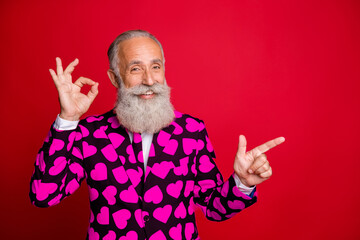 Photo of funky aged handsome man amour direct finger empty space show okey symbol advising novelty...