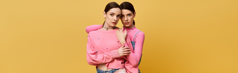 Two lovely sisters showcase their bond while wearing matching stylish attire in a playful setting