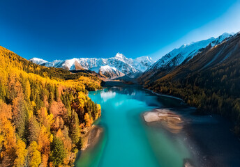 Fototapeta premium Breathtaking landscape in China showcasing a turquoise river winding through colorful autumn forests and majestic snow-capped mountains under a clear blue sky.