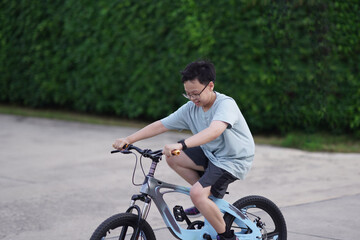 boy cycling bicycle on road