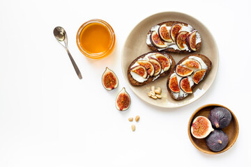 Breakfast with figs and cheese toasts with honey, top view