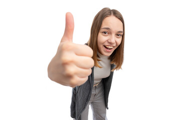 A young woman smiling and giving a thumbs up gesture against a white background.