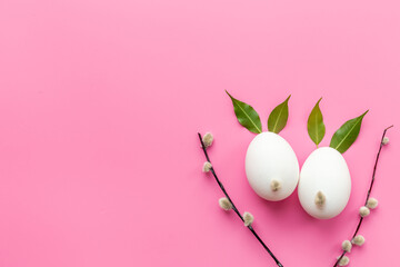 Handmade Easter decoration - eggs in shape of bunny with spring leaves and willow buds, top view