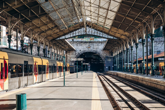 Porto, Portugal - December 28, 2024: Yellow train of Comboios de Portugal at Sao Bento station in Porto, Portugal