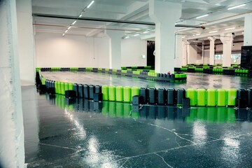Indoor go-kart track with colorful barriers.