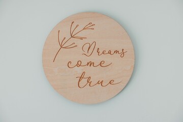 Wooden disc with engraved phrase and botanical art