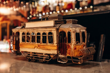 A figurine of a traditional Portuguese tram on a bar counter in Porto, Portugal