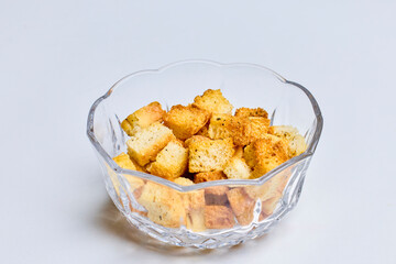 a glass bowl of croutons on a table