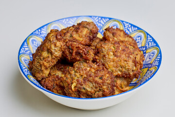 a bowl of pork meatballs on a table