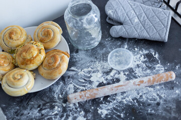 A close-up view of freshly baked swirl pastries resting on a parchment-lined baking tray.