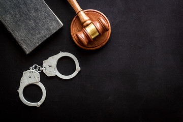 Judges gavel and police metal handcuffs, top view. Criminal offense and detention concept