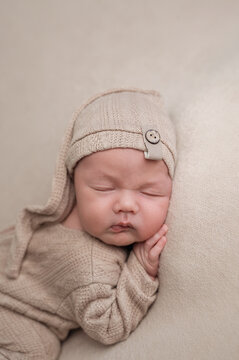 Peaceful newborn asleep in cozy knit outfit