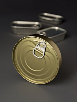 Close up of metallic tin food can with pull tab on gray surface