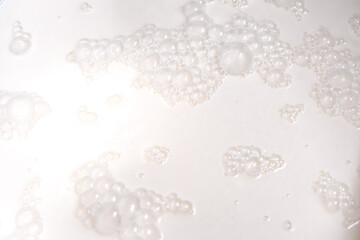 Background with milk texture, close-up milk bubbles.