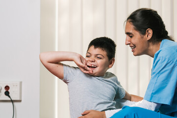 Physiotherapist assisting a child with disability with cerebral palsy during therapy session