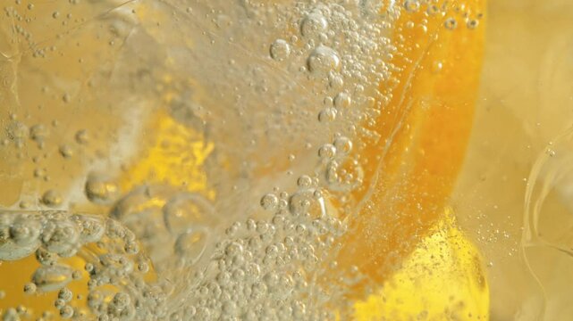 Super Slow Motion Detail Shot of Lemon and Ice in Sparkling Water at 1000fps.