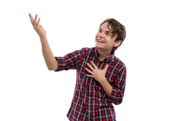 A young man in a plaid shirt smiling and gesturing with his hand against a white background.