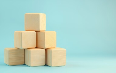 A collection of wooden blocks arranged in a playful stack on a light blue background, ideal for educational or creative concepts.