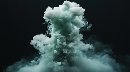 Teal smoke plume rising against black background, special effects