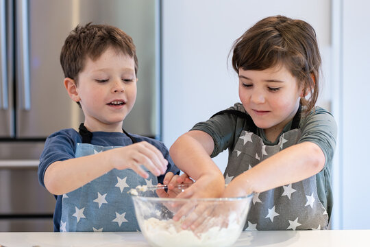 Siblings Enjoying Baking Together in the Kitchen