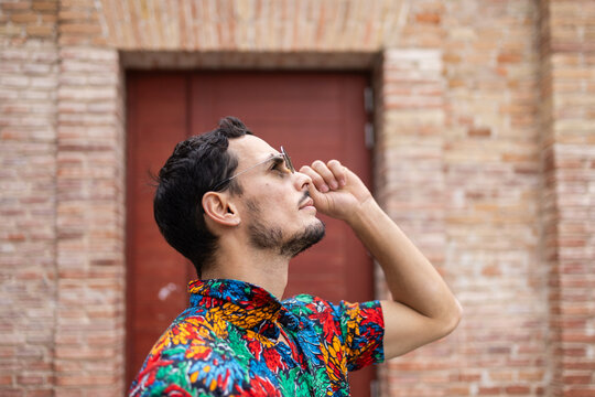 Cuban man in colorful shirt with confident pose outdoors