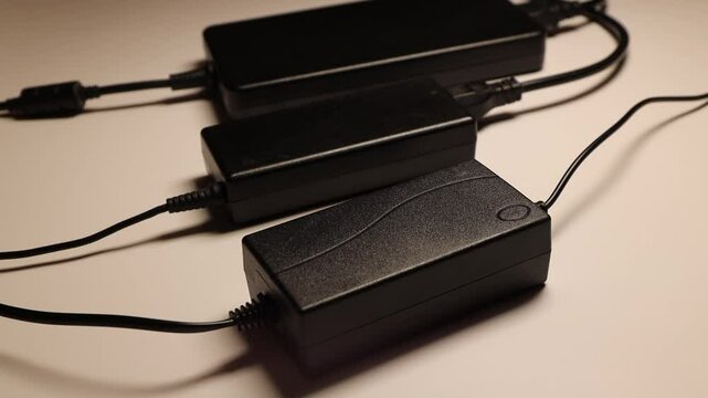 Laptop chargers. Computer power supply on a dark background. laptop accessories