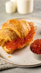 Croissant with red salmon caviar