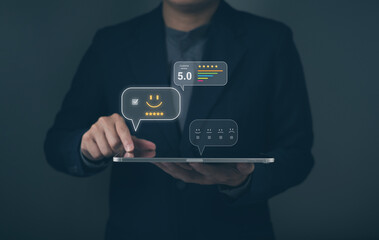 person in a suit interacts with a tablet, displaying floating feedback icons, including ratings and emoticons, emphasizing customer satisfaction.