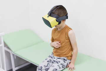 Caucasian boy in vr glasses clinic
