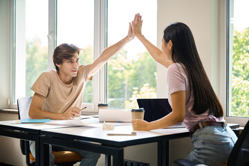 Fototapeta premium Team of young creatives celebrates victory