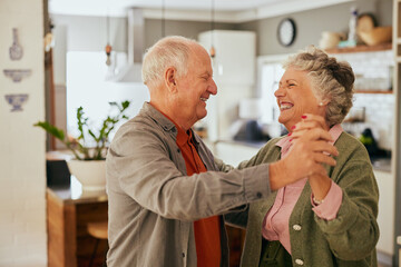 Loving senior couple dancing at home with joy