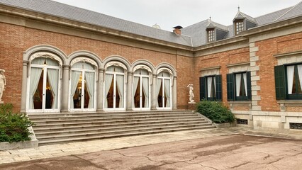 Fototapeta premium Palace in Barcelona with ornate brick and stone walls, arched windows and decorative architectural features. King's residence in his official visits to the city