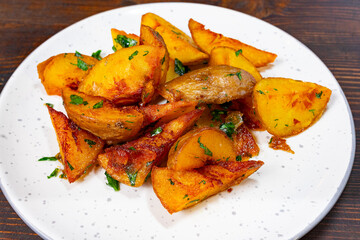 Deliciously roasted potatoes with herbs on a white plate Savory vegetable pie served with fresh garnishes