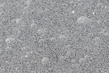 Texture of ice on a frozen pond with multiple air bubbles