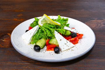 Fresh salad with vegetables and cheese served on a plate in a cozy setting Savory vegetable pie served