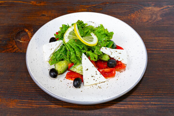Fresh salad with vegetables and cheese on a wooden table Savory vegetable pie served with fresh garnishes