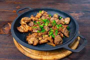 Sizzling beef dish with green onions on cast iron skillet Savory vegetable pie served with fresh garnishes